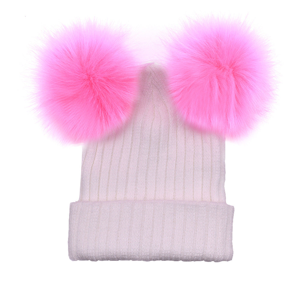 White beanie with pink pom-poms